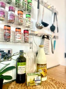 a counter with bottles of food on a shelf at Dreghorn House 5 b-rooms 9 beds 3 toilets 2 showers,1 bath 2 receiption Secure free Parking 233 Wifi in Edinburgh +27 photos