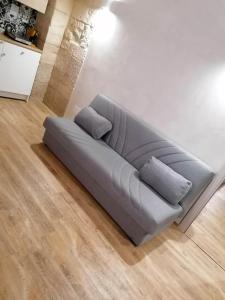 a gray couch in a living room at LA DIMORA DEL PRINCIPE-Loft in Trani