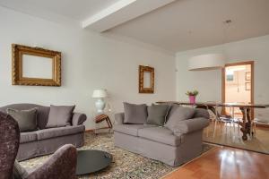 a living room with two couches and a table at Apartments Florence Menicucci in Florence