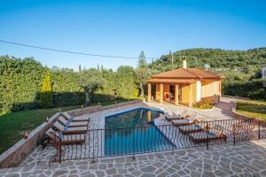 a swimming pool with chairs and a house at Villa Totta in Alikanas