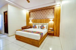 a bedroom with a large bed in a room at FabHotel Rotano Grand in Bangalore