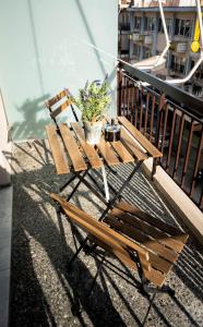eine Holzbank auf einem Balkon mit Topfpflanze in der Unterkunft Downtown Luxury Apartments 34 in Ioannina
