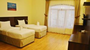 Postel nebo postele na pokoji v ubytování Weekdays Hotel