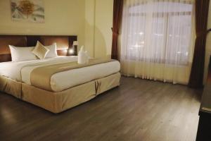Postel nebo postele na pokoji v ubytování Weekdays Hotel