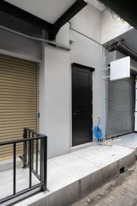a black door on the side of a building at CASA BLANCA Dusit in Dusit