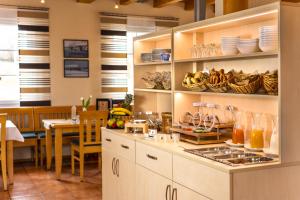 a kitchen with white cabinets and a dining room at Familiengasthof Schaller in Floß