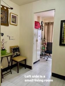 a room with a small living room with a table and a refrigerator at Condominium Suites at Chateau Elysee - Ritz in Manila