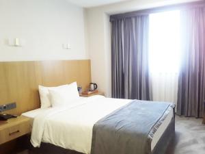 a hotel room with a bed and a window at Asli Makon Hotel in Tashkent +21 photos