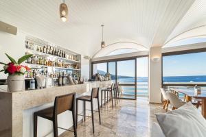 a bar in a restaurant with a view of the ocean at Hotel Perrakis in Kipri