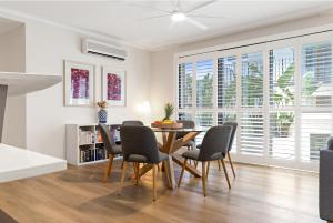 a dining room with a table and chairs at City oasis - 3 BR apt. on Maroochy river, pool, AC in Maroochydore