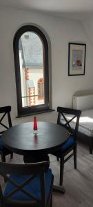 a room with a table and chairs and a bed at Templerhaus Boppard in Boppard +55 photos