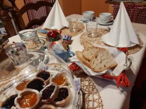 a table with a plate of food on a table at B&B La Margine e SPA in Cocciglia