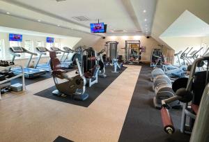 a gym with lots of treadmills and cardio machines at Rowan Boutique Lodge for couples with a dog in York