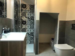 a bathroom with a sink and a toilet and a shower at SUPER APPARTAMENTO TERRAZZA PANORAMICA 3 CAMERE in Villasimius +36 photos