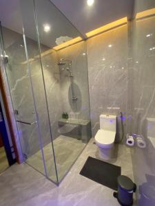 a bathroom with a shower and a toilet at Gwandalan House in Dipolog