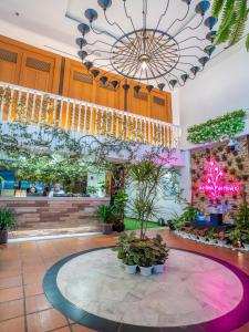 a large lobby with plants and a chandelier at Floresta Hotel Chinatown in Kuala Lumpur