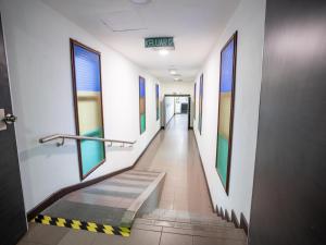 a hallway in a hospital with a stairway at Floresta Hotel Chinatown in Kuala Lumpur