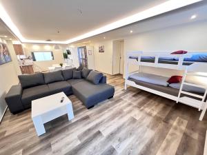 a living room with a couch and bunk beds at Pension am Schloss in Schwerin