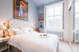 ロンドンにあるTREE HOUSE Celebrity Residence in Notting Hillのベッドルーム(トレイ付きの白い大型ベッド1台付)