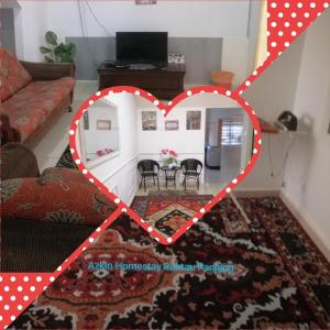 a heart shaped room with a table in a living room at Sobey Laris Homestay RANTAU PANJANG in Pasir Mas