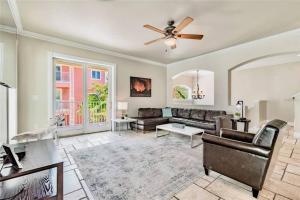 a living room with a couch and a ceiling fan at Luxury Beach House - steps to the beach in Clearwater Beach