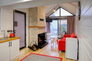 a living room with a red couch and a fireplace at World DREAMS Sapanca in Sakarya