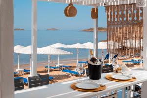 a table with a view of the beach from a restaurant at Hotel Perrakis in Kipri