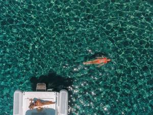 a person swimming in a pool of water at Hotel Perrakis in Kipri
