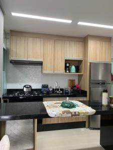 a kitchen with a island in the middle of it at Apto aconchegante e elegante Morretes itapema in Meia Praia