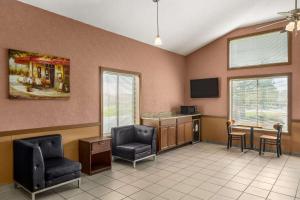 a waiting room with two chairs and a table at Days Inn by Wyndham Canastota Verona in Canastota