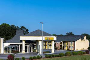 a building with a sign on the front of it at Super 8 by Wyndham McDonough GA in McDonough