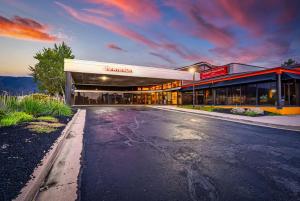 an empty parking lot in front of a building at Ramada by Wyndham Cedar City in Cedar City