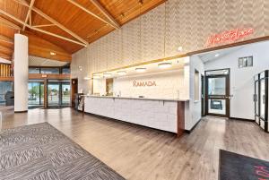 an empty lobby with a counter in a store at Ramada by Wyndham Cedar City in Cedar City +37 photos