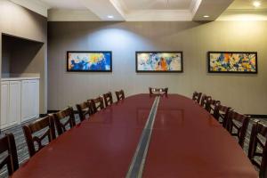 a conference room with a long table and chairs at La Quinta by Wyndham Bridgeport in Bridgeport