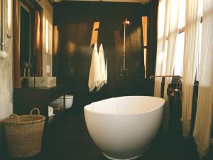 a bathroom with a large white tub and a sink at Mona Athens in Athens