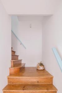 a staircase in a house with wooden floors at Casa Azul do Olival in Alcácer do Sal