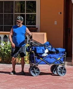 a man standing next to a blue stroller at RELAX @ BEACH, BIBIJAGUA in Punta Cana