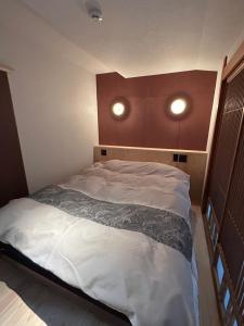 Postel nebo postele na pokoji v ubytování Sangai Ryokan