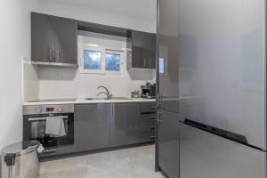 a kitchen with stainless steel appliances and a window at Marvelous, Secluded Villa w/ 3 BR , Pool & Garden, Kavos in Isthmia