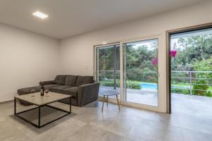 a living room with a couch and a table at Marvelous, Secluded Villa w/ 3 BR , Pool & Garden, Kavos in Isthmia