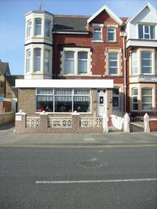 un bâtiment à l'angle d'une rue en face d'une maison dans l'établissement Dora Hotel, à Blackpool