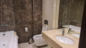 a bathroom with a sink and a toilet and a tub at Suite Roma 1 at Royal Spa in Velingrad