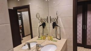 a bathroom with two sinks and a mirror at Suite Roma 1 at Royal Spa in Velingrad