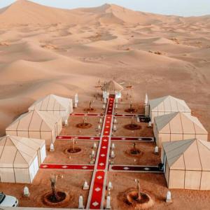 a desert camp in the middle of the desert at Merzouga Desert Luxury Camp in Merzouga