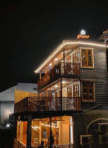 a large building with balconies on it at night at D' more Sajek Valley Hotel & Resort in Māhmuam