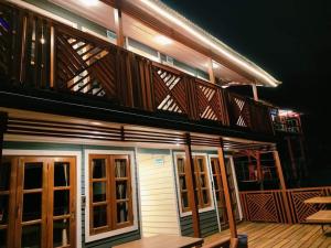un edificio con balcone, pavimenti in legno e finestre di D' more Sajek Valley Hotel & Resort a Māhmuam