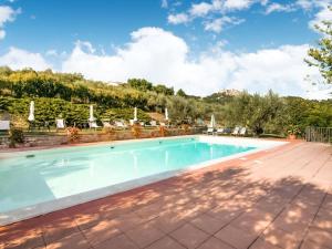 a swimming pool in a villa with a mountain in the background at Tranquil Farmhouse in Umbria in Monte Santa Maria Tiberina