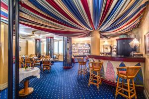 a restaurant with tables and chairs and a curtain at Hotel Auriga in Milan