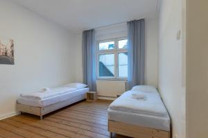 um quarto com duas camas e uma janela em T&K Apartments - Duisburg - 4 Rooms Apartment - 2nd Floor em Duisburg