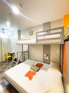 a bedroom with a bunk bed with orange accents at Corazon Tourist Inn in Puerto Princesa City